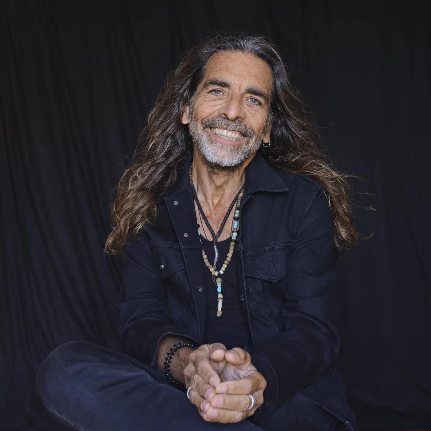 Robert Fox smiling, in a dark denim jacket
